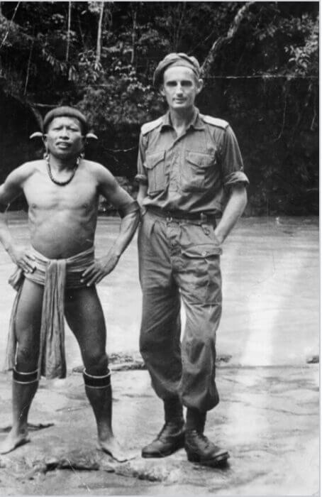 Soldier standing by river wither Japanese native